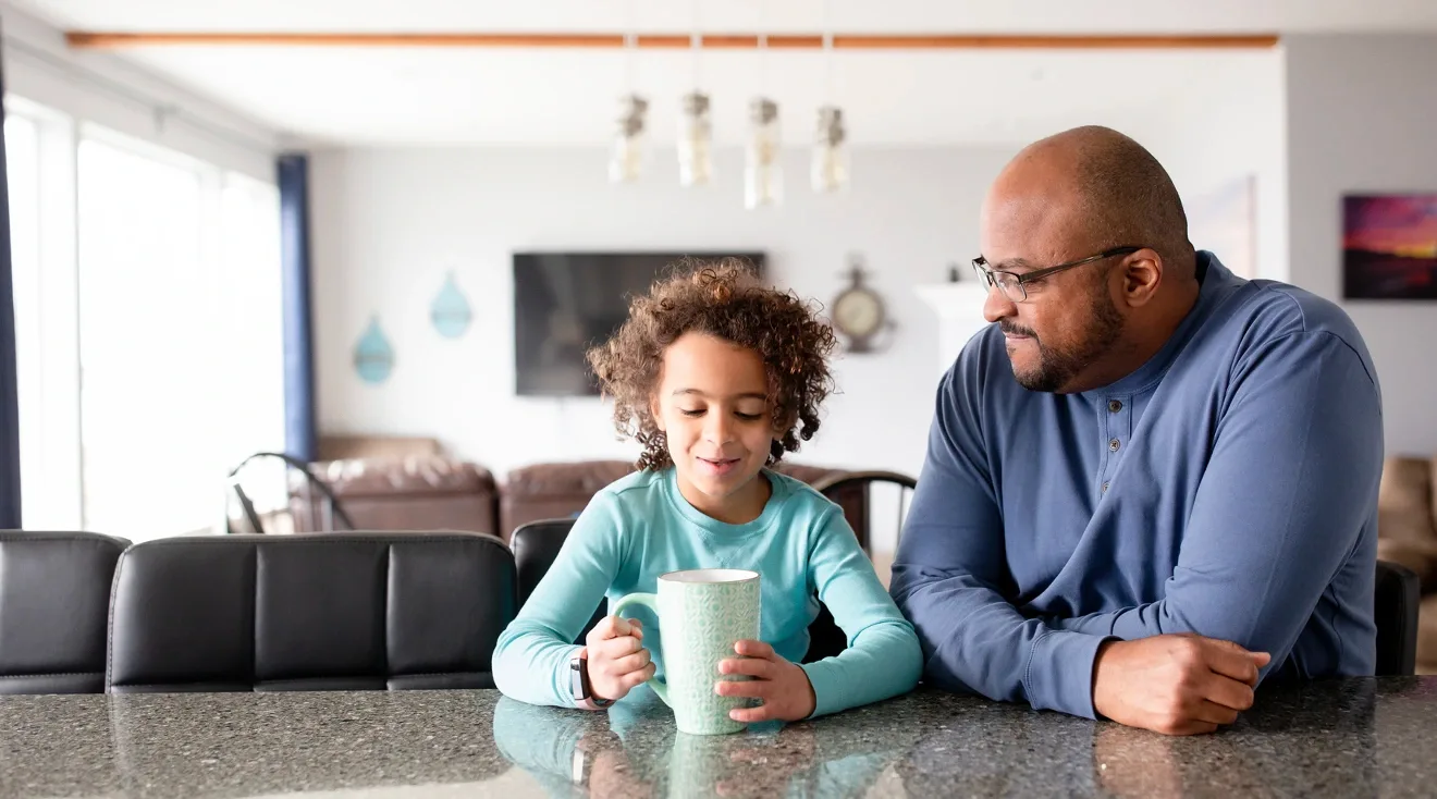 father and daughter sitting and talking at home