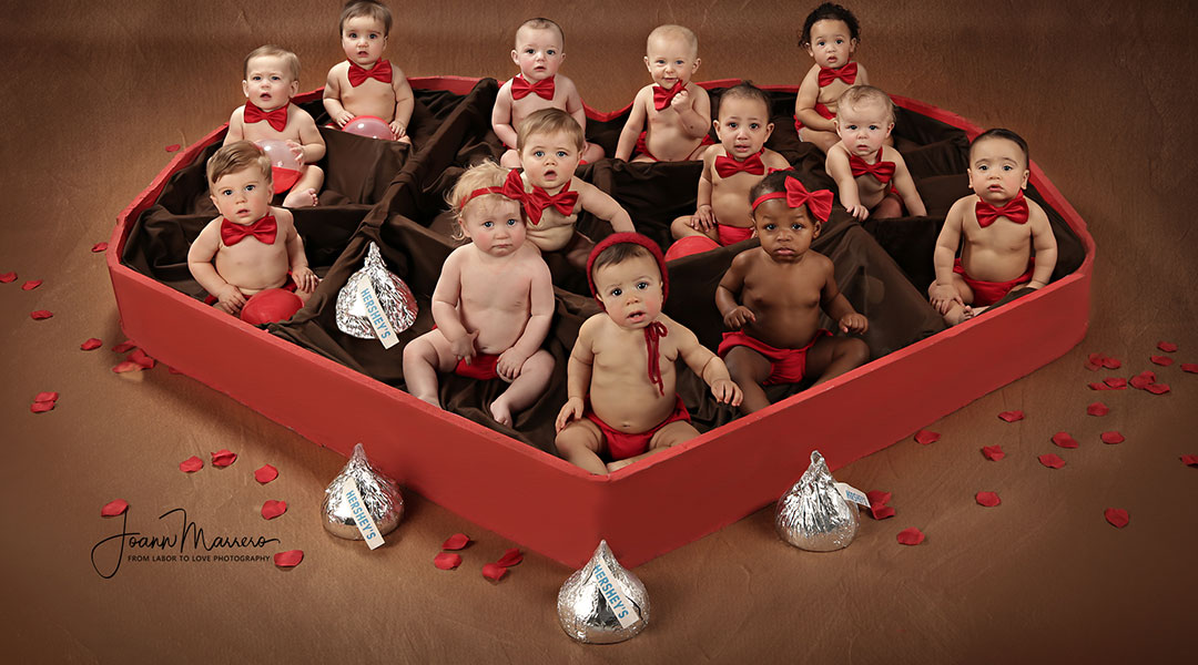 babies dressed up for valentines day in a chocolate heart box