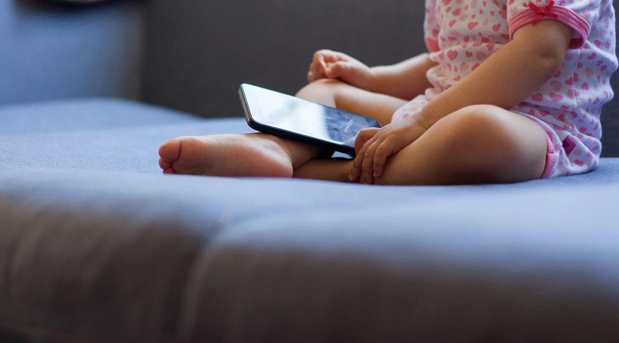 toddler playing with phone during screen time