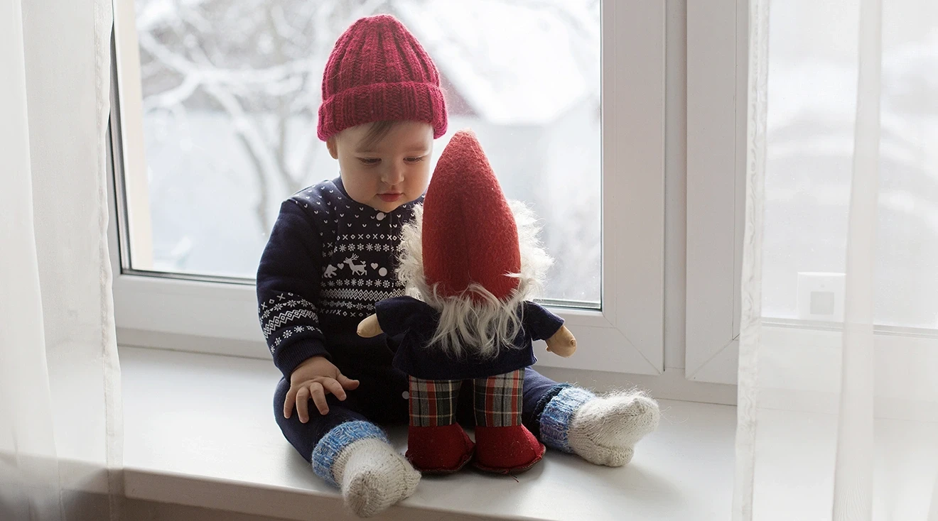 baby wearing winter hat at home