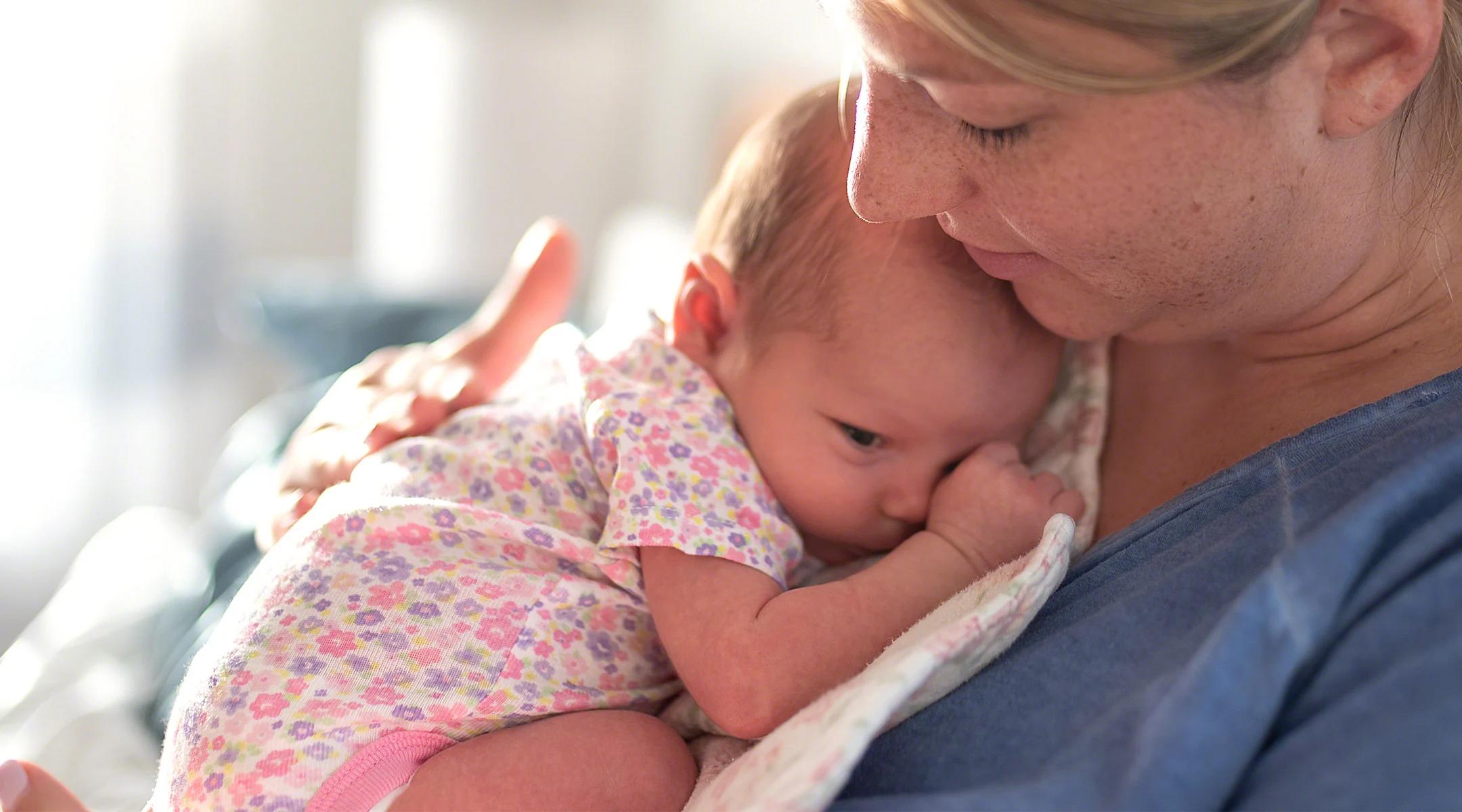 new mom holding her newborn baby after delivery