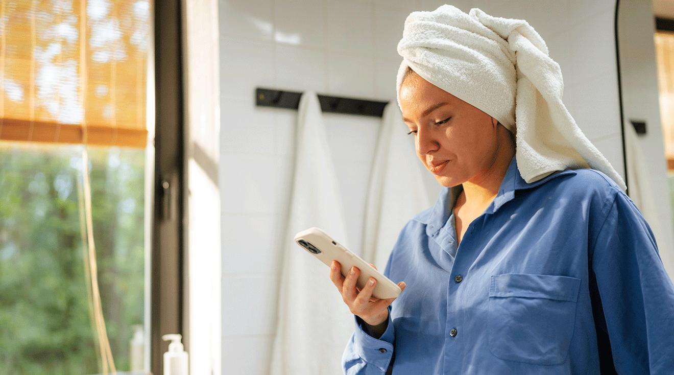 young woman looking at phone in bathroom