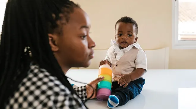 exhausted mother playing with toddler
