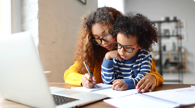 mom helping child do school work at home
