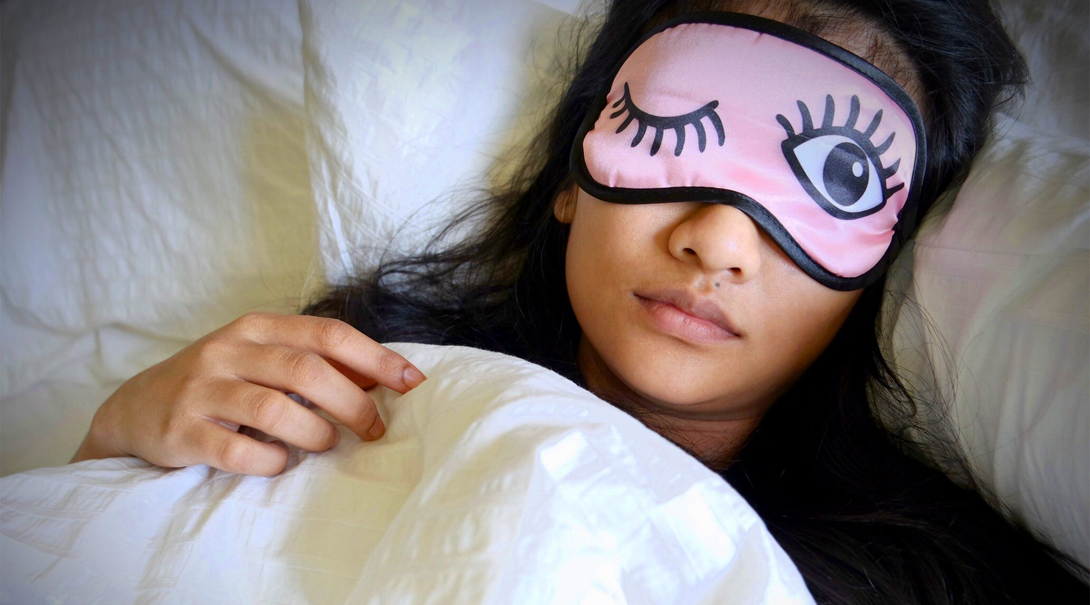 tired mom sleeping with funny sleep mask