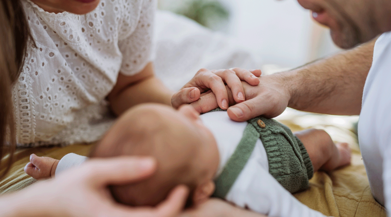 mom and dad with newborn baby