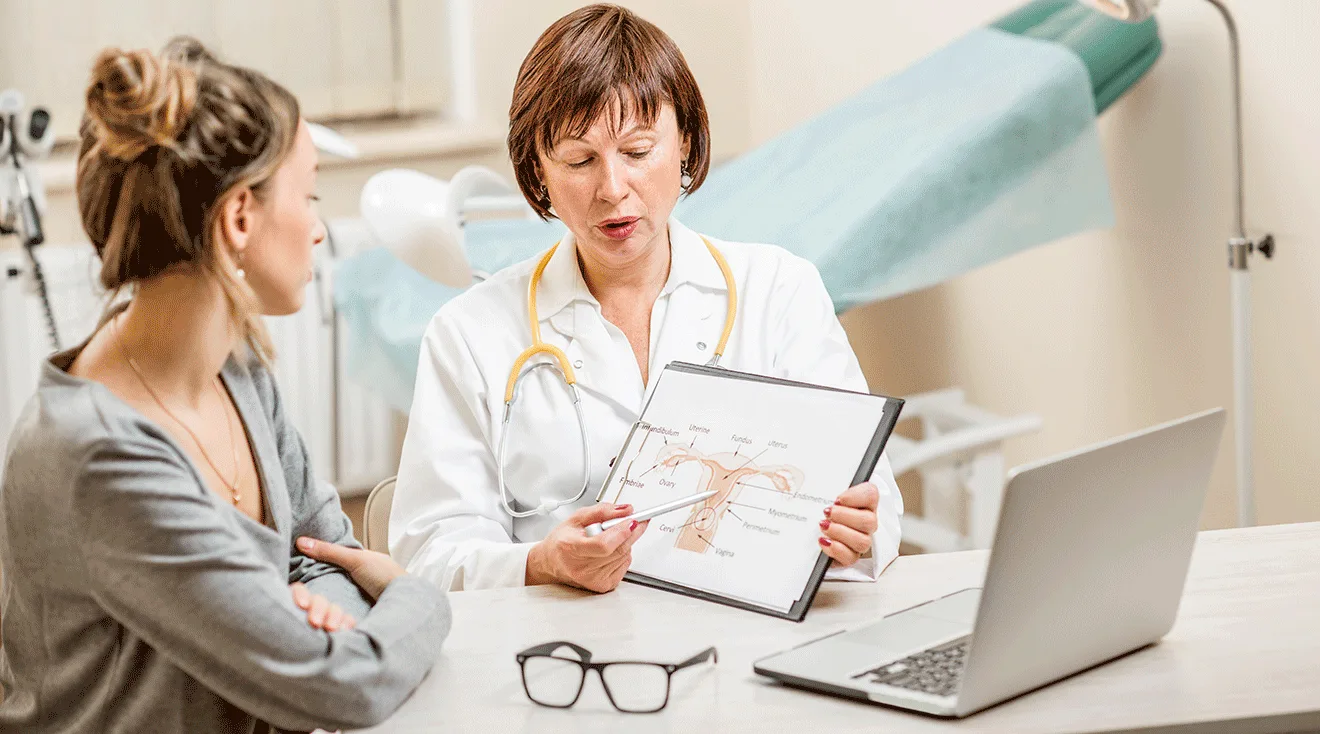 gynecologist doctor talking to patient in exam room