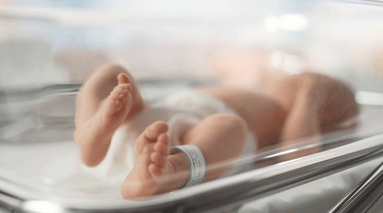 newborn baby in hospital bed