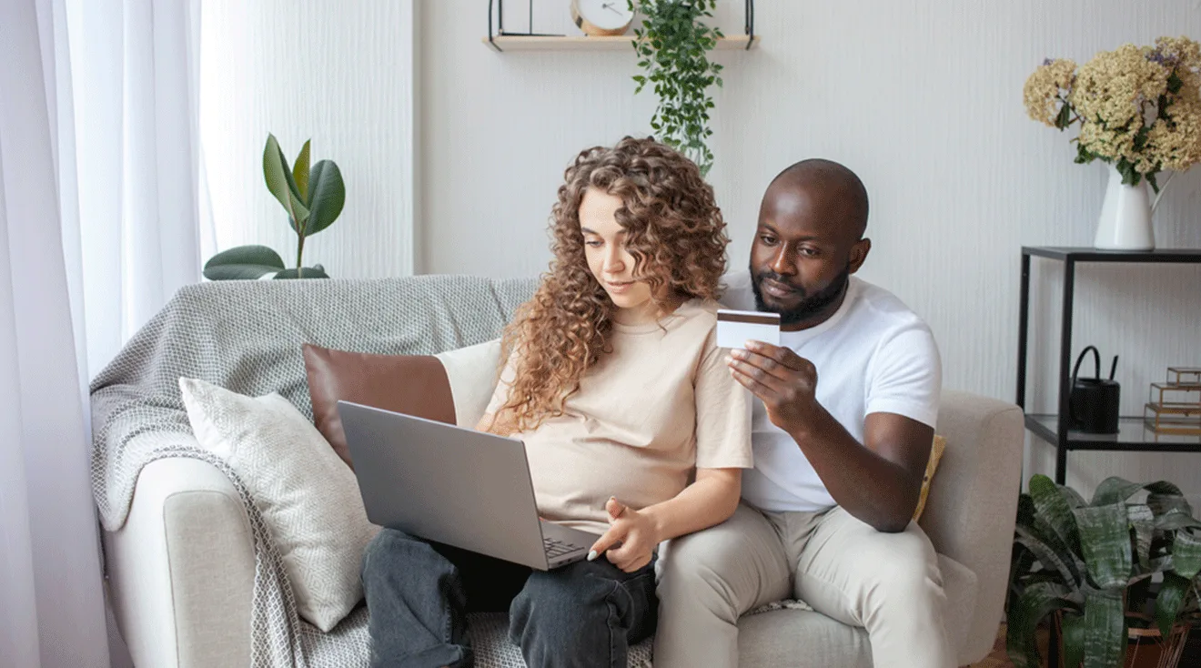 pregnant couple shopping online at home