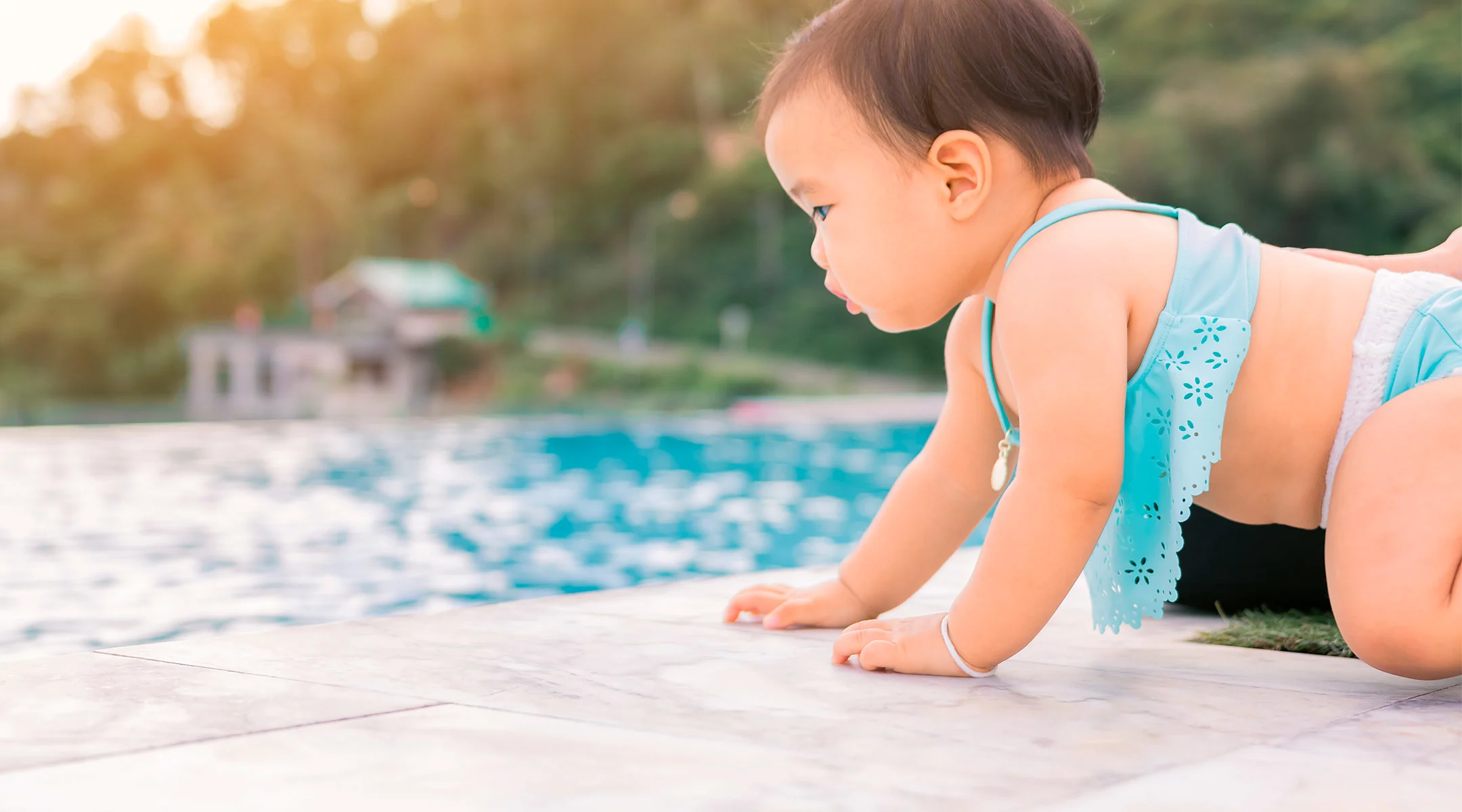 toddler climbing into pool