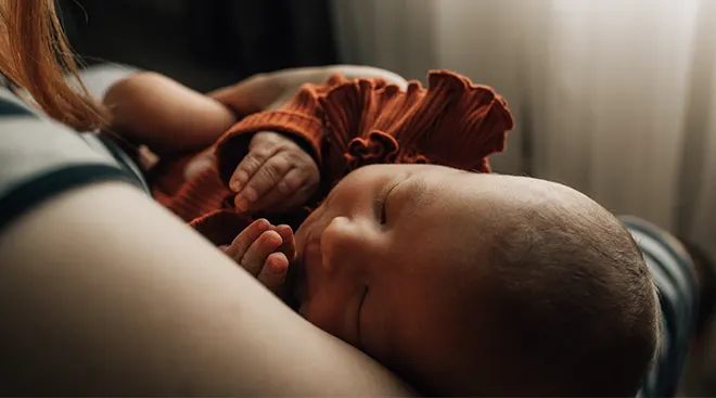 close up of mother holding baby at the end of the day
