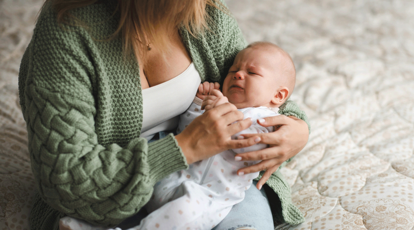 mom comforting crying baby