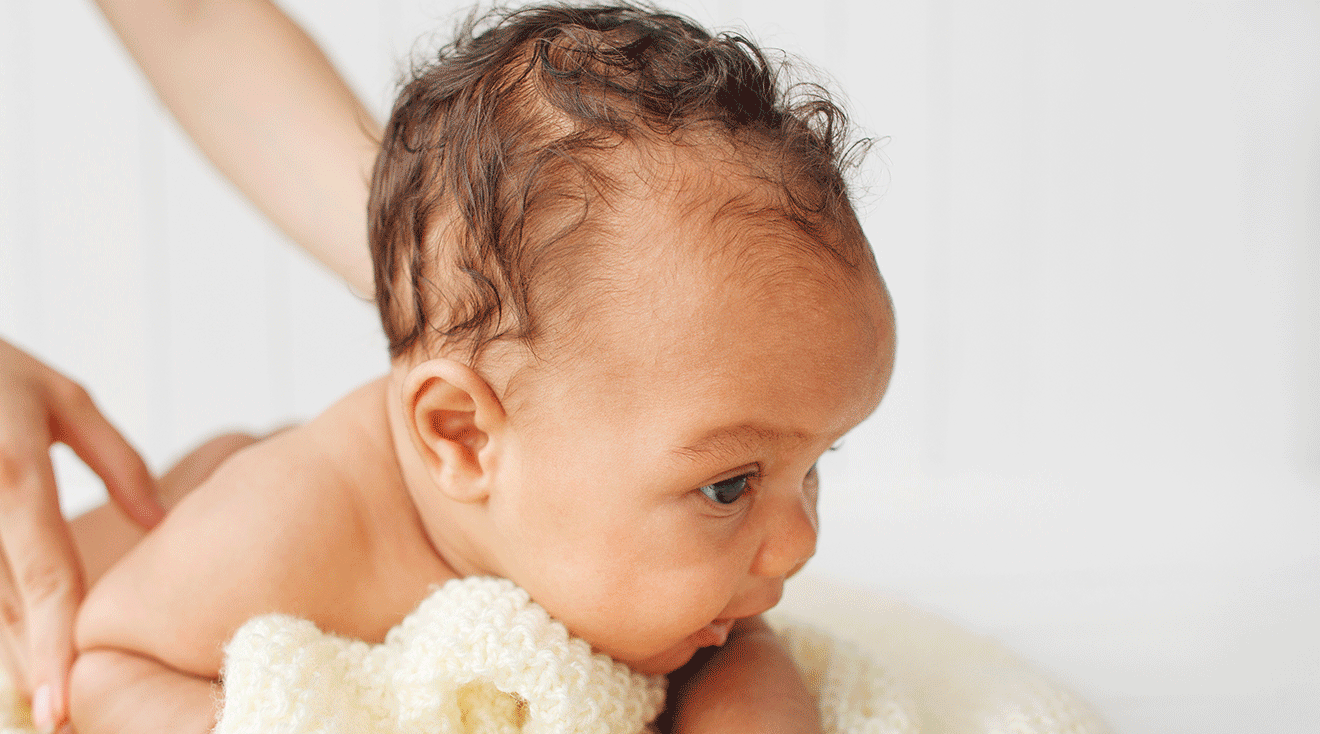 baby doing tummy time while holding head up