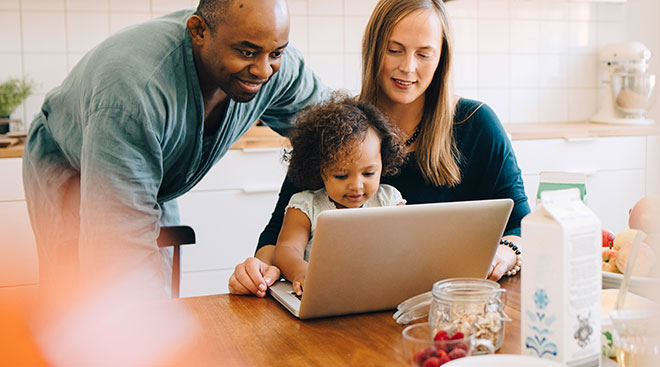 toddler with parents doing homeschool online