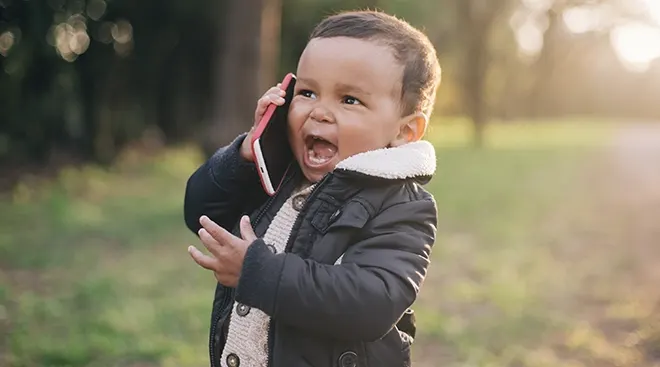 baby talking on the phone outside