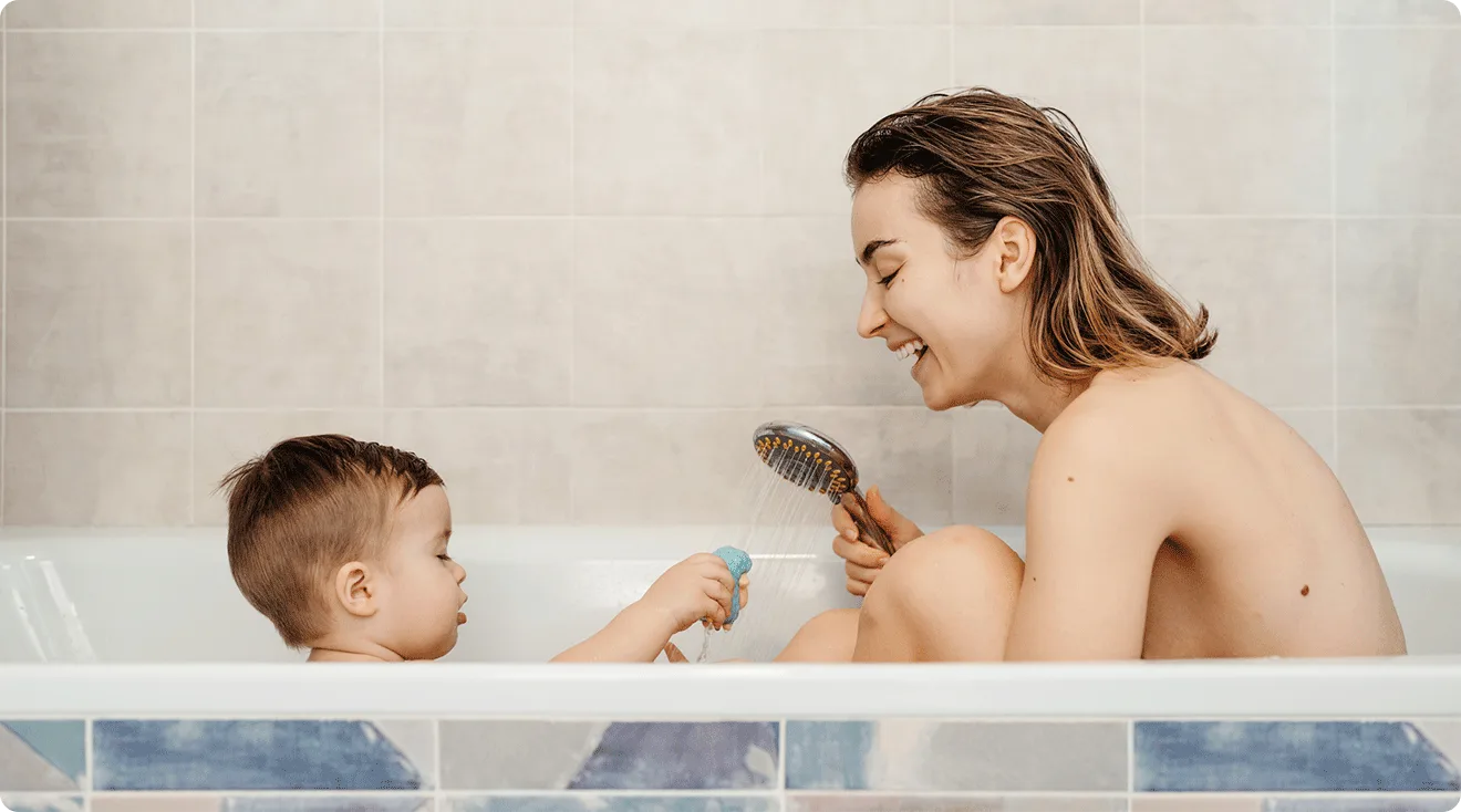 mom bathing with her toddler, a common scene for a "naked mom" or "naked family"