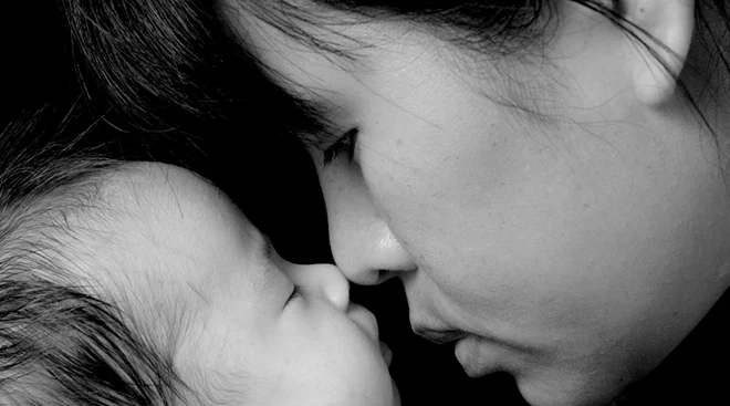 mother and baby touching noses, black and white image