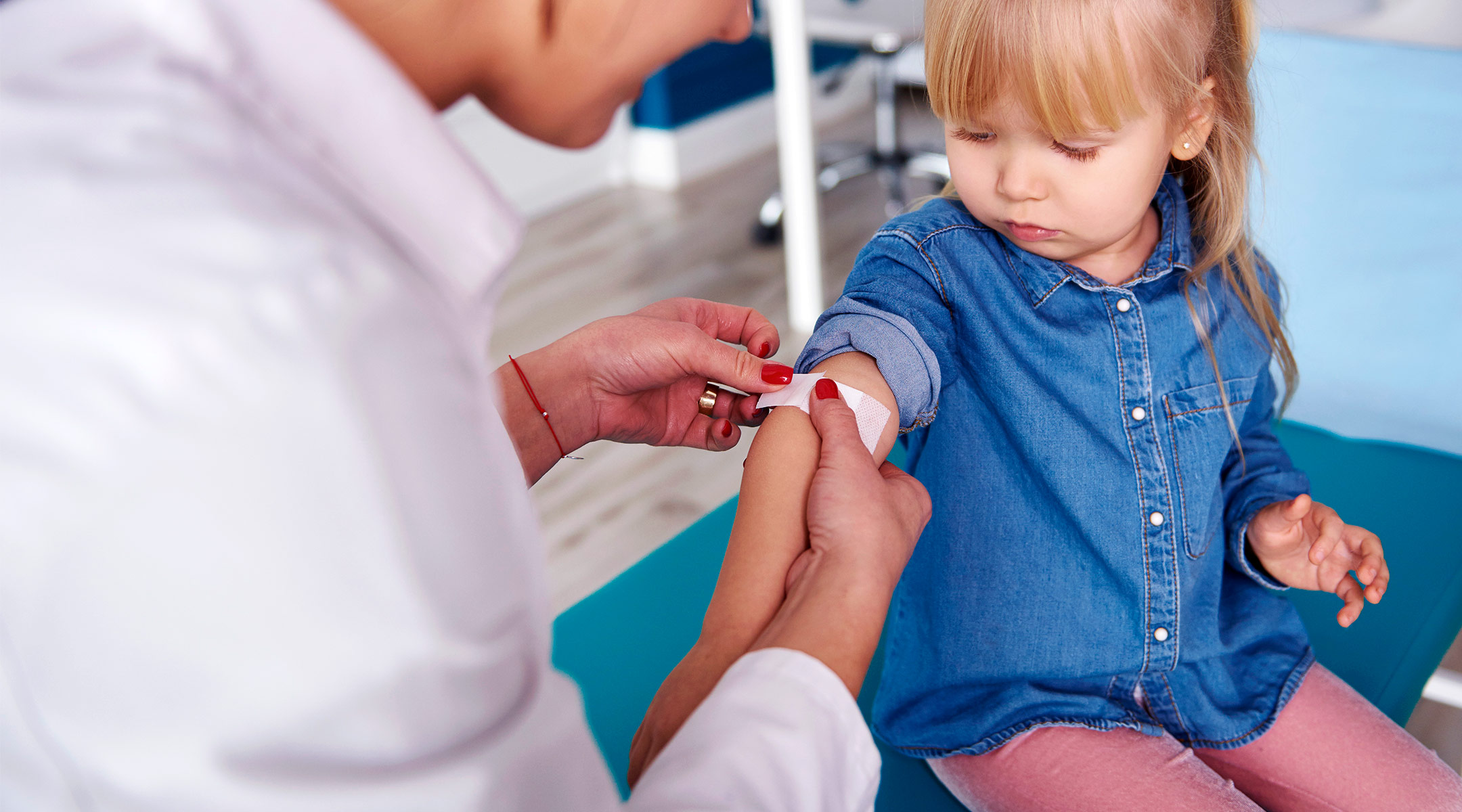 toddler girl getting her flu vaccine at doctor's