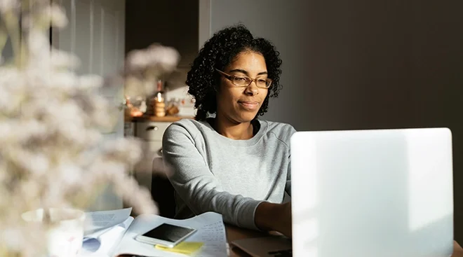 young woman working on laptop at home