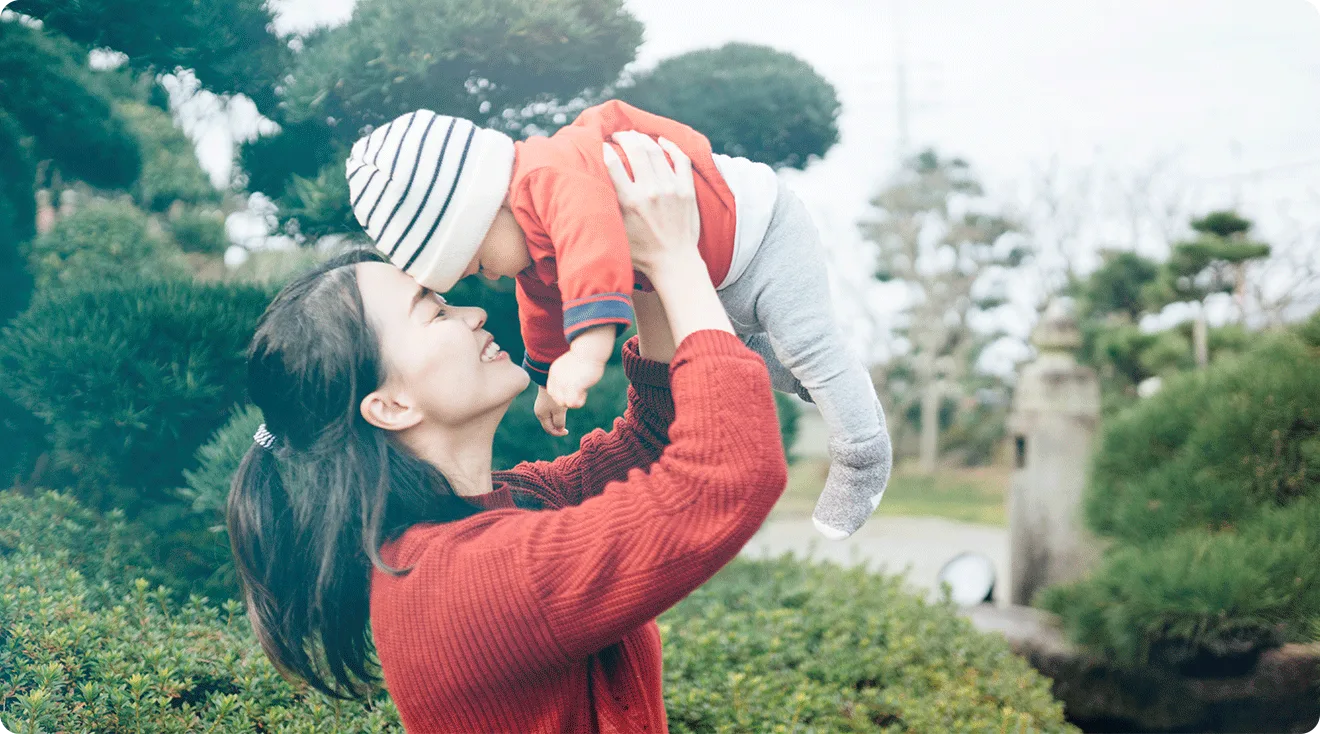 mom holding baby outside in japan