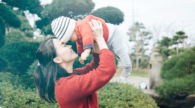 mom holding baby outside in japan