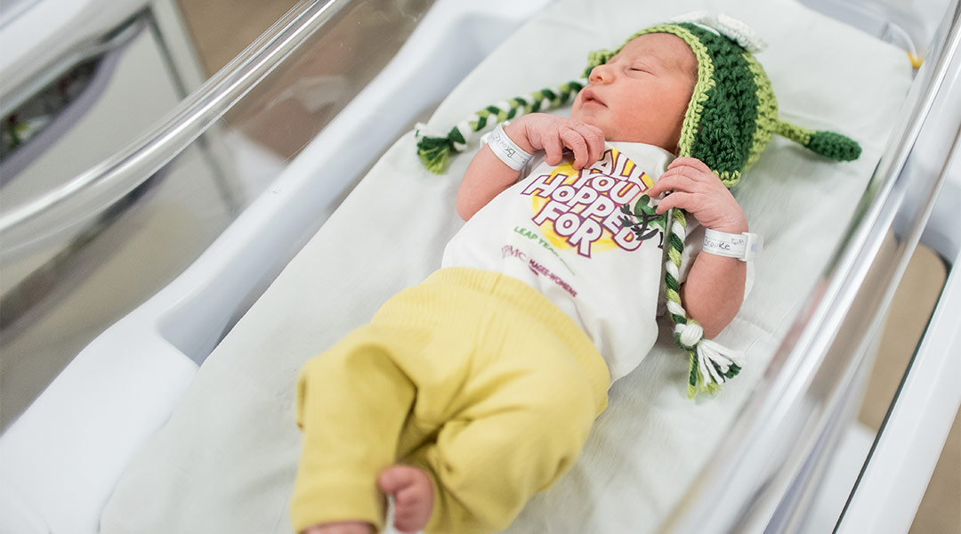 nicu babies dressed in grasshopper hats for leap day