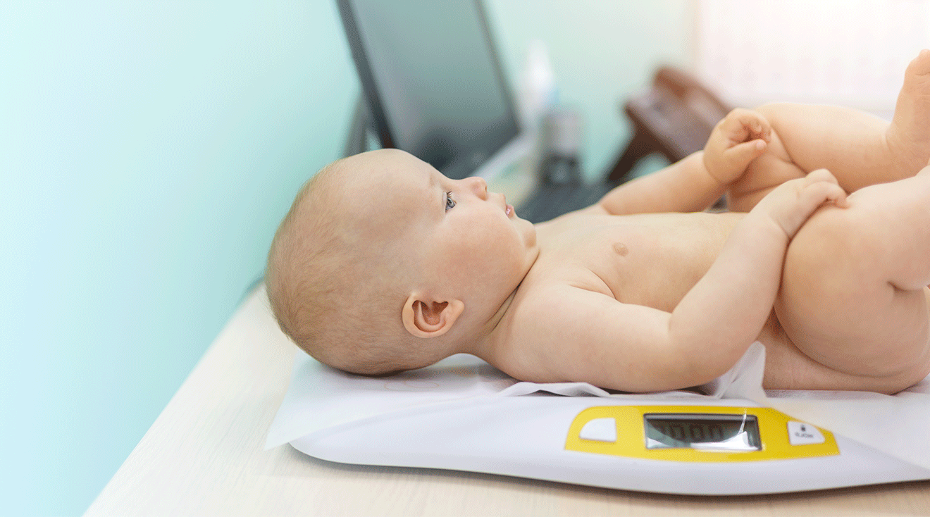 baby on weight scale in doctor's office