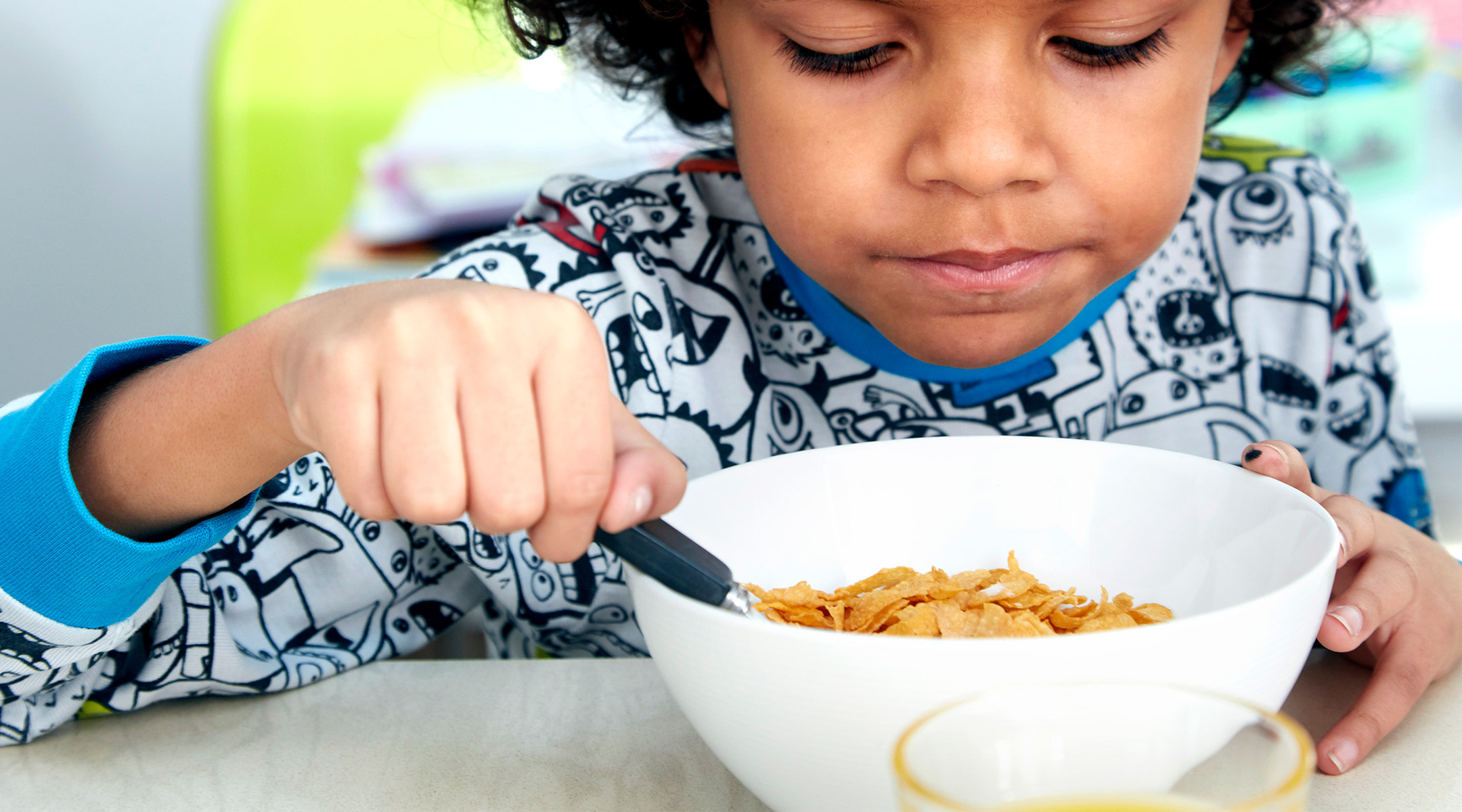 child eating his breakfast cereal