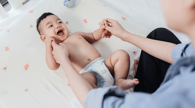 mom playing with smiling baby