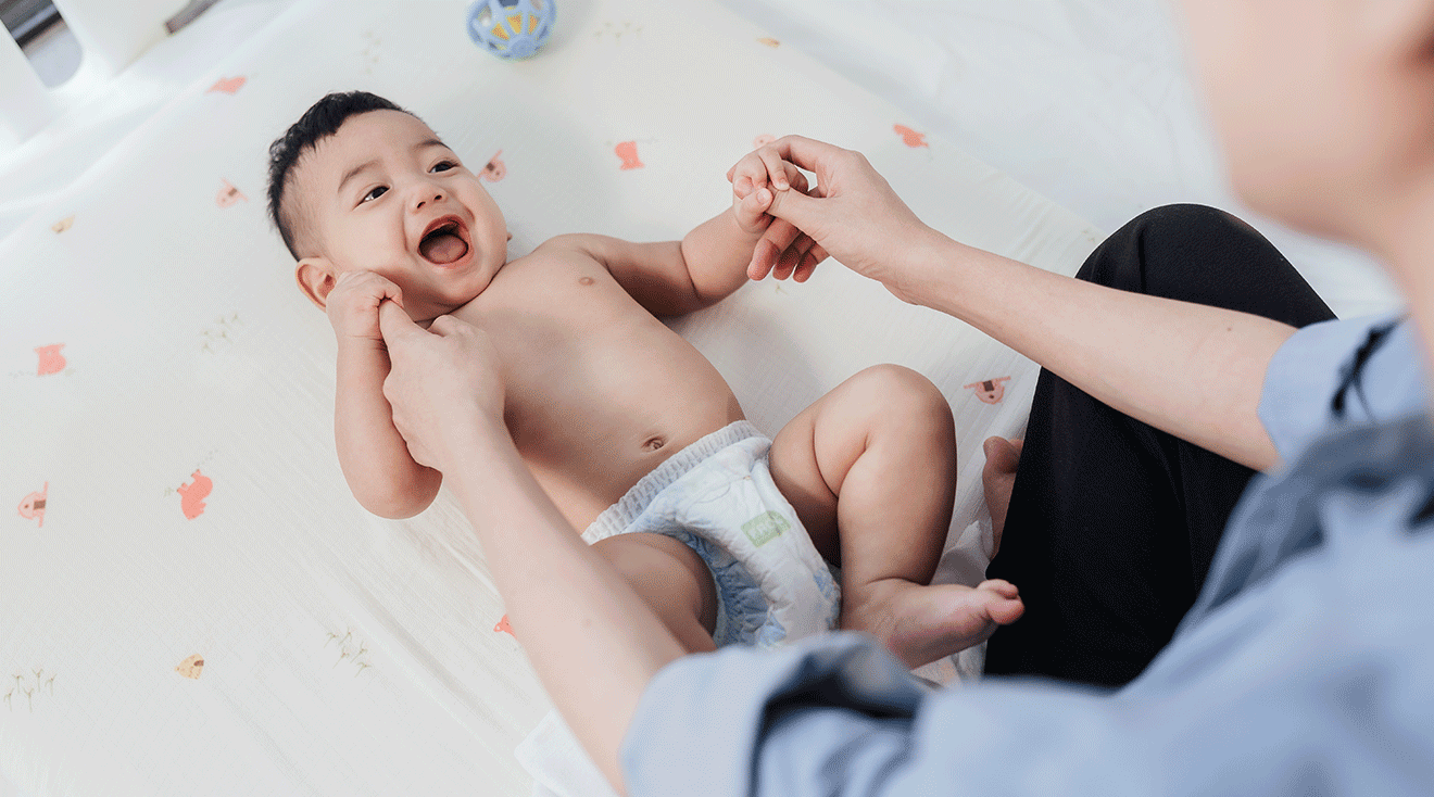 mom playing with smiling baby