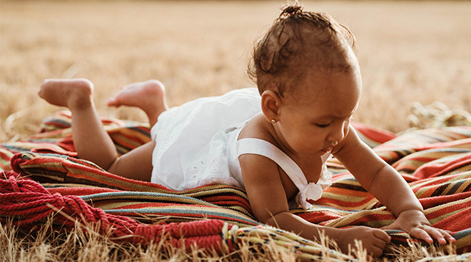 Baby laying on her stomach trying tummy time. 