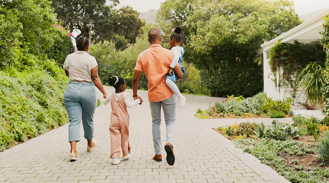 black family walking outside holding hands