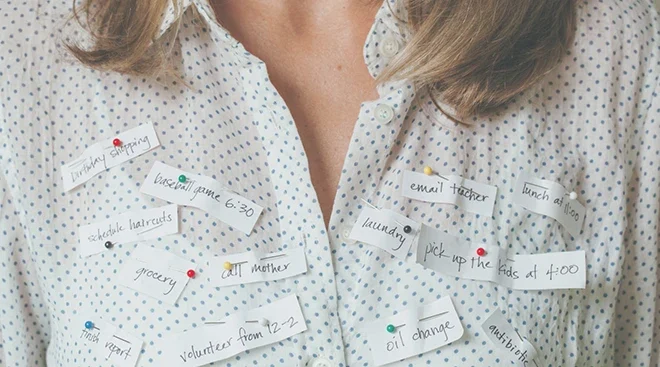 close up of reminders pinned on mother's blouse