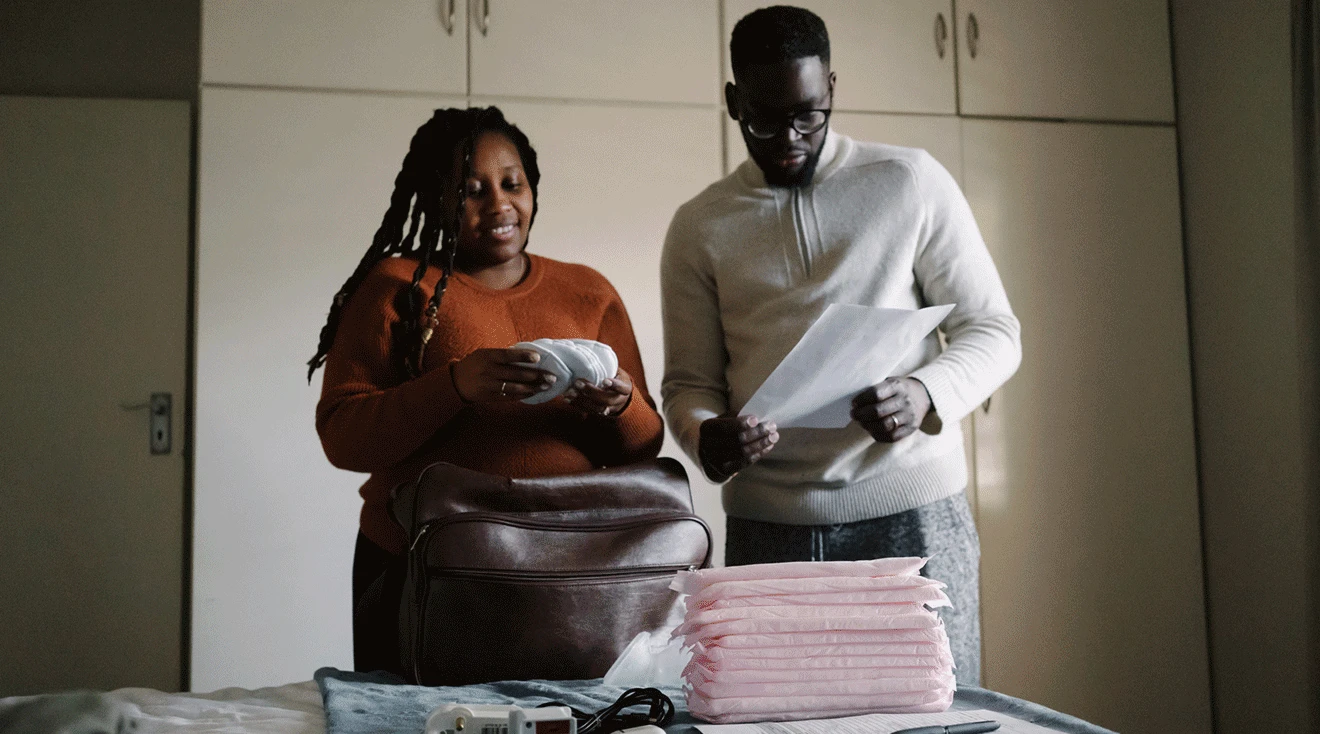 couple packing hospital bag for birth