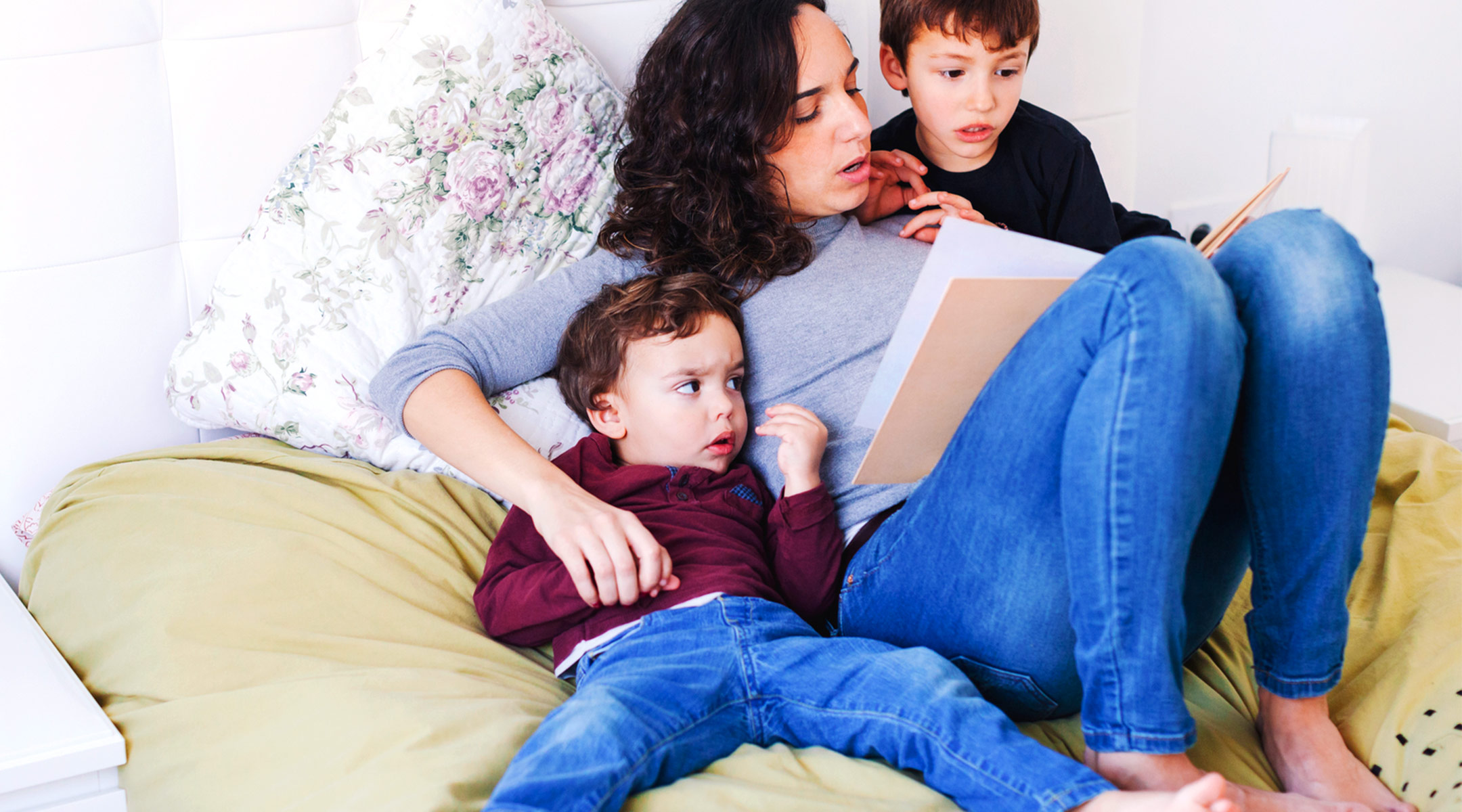 mom reading her young children a hanukkah book