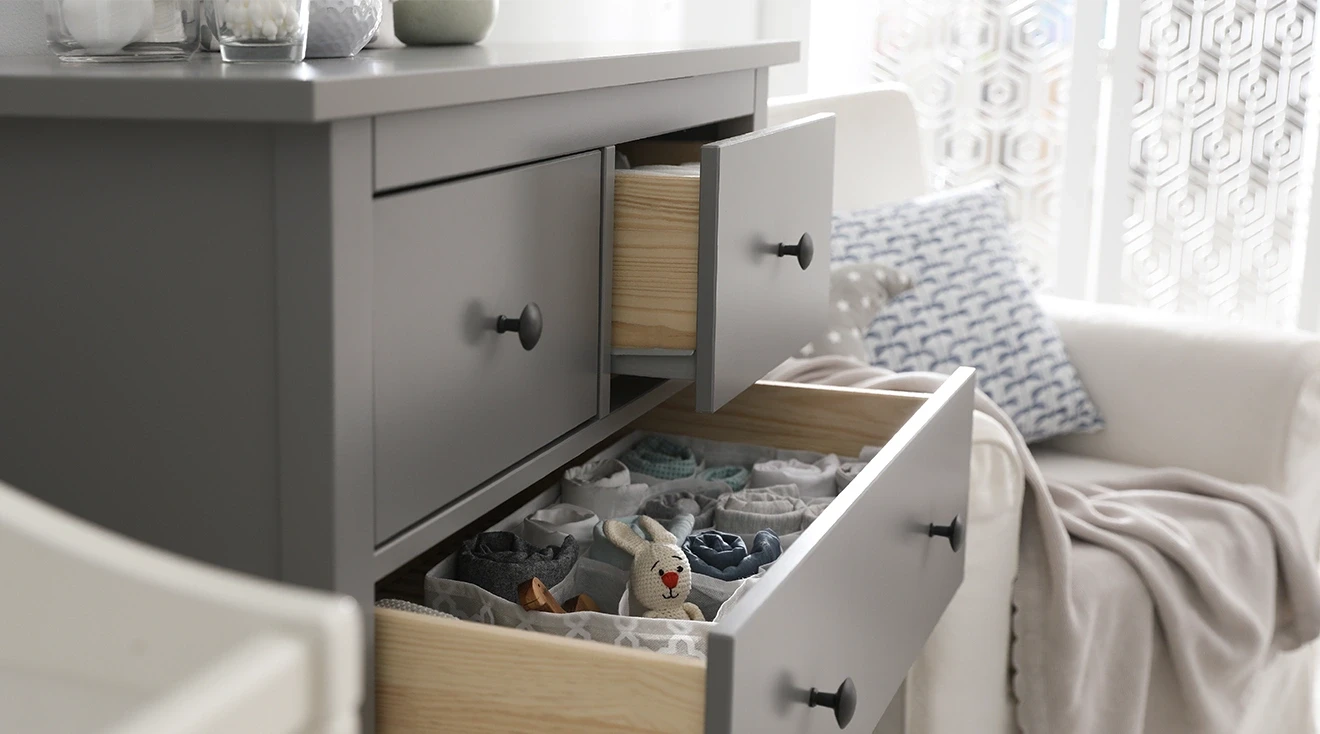 open drawers of dresser in baby nursery room