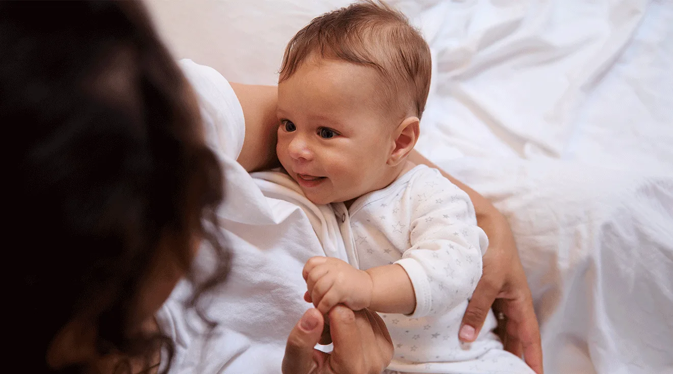mom holding baby in arms