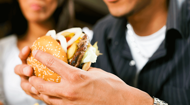 young man eating a burger