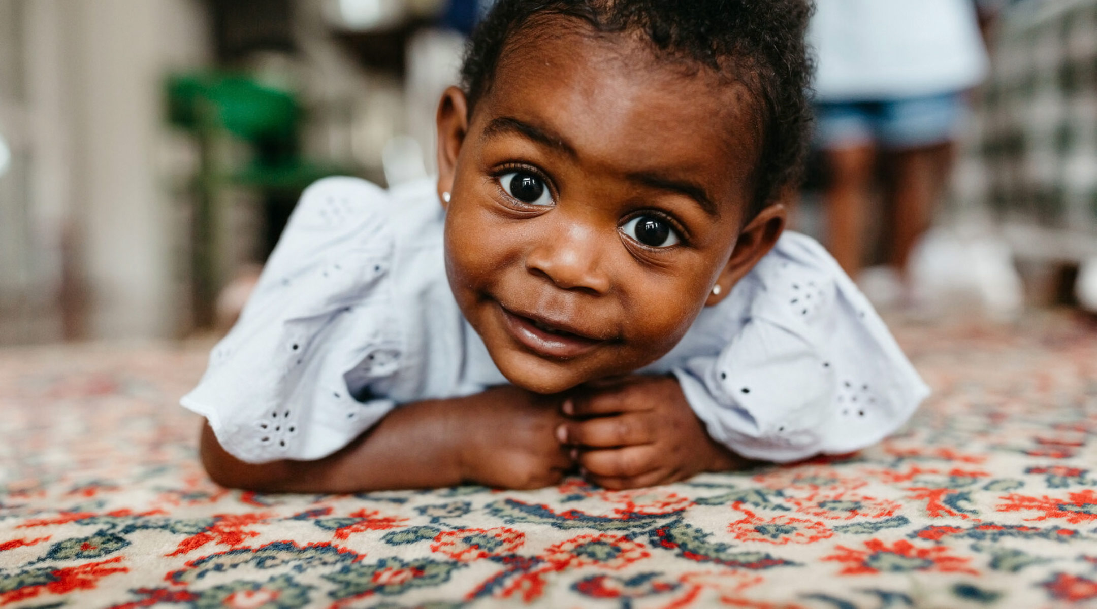 close-up of happy baby doing tummy time