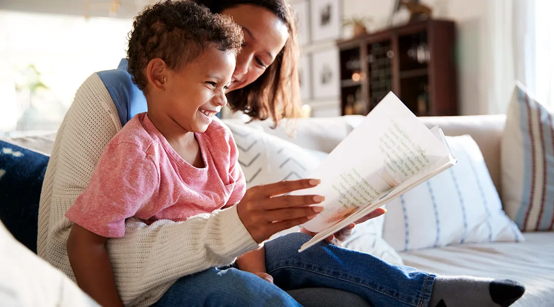 mom reading a book to her toddler son