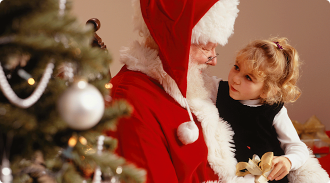 little girl sitting on santa's lap