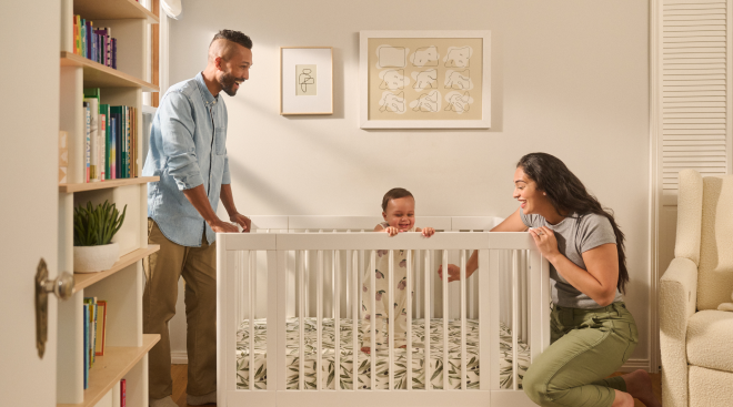 mom and dad playing with baby in Babyletto Yuzu 8-in-1 Convertible Crib