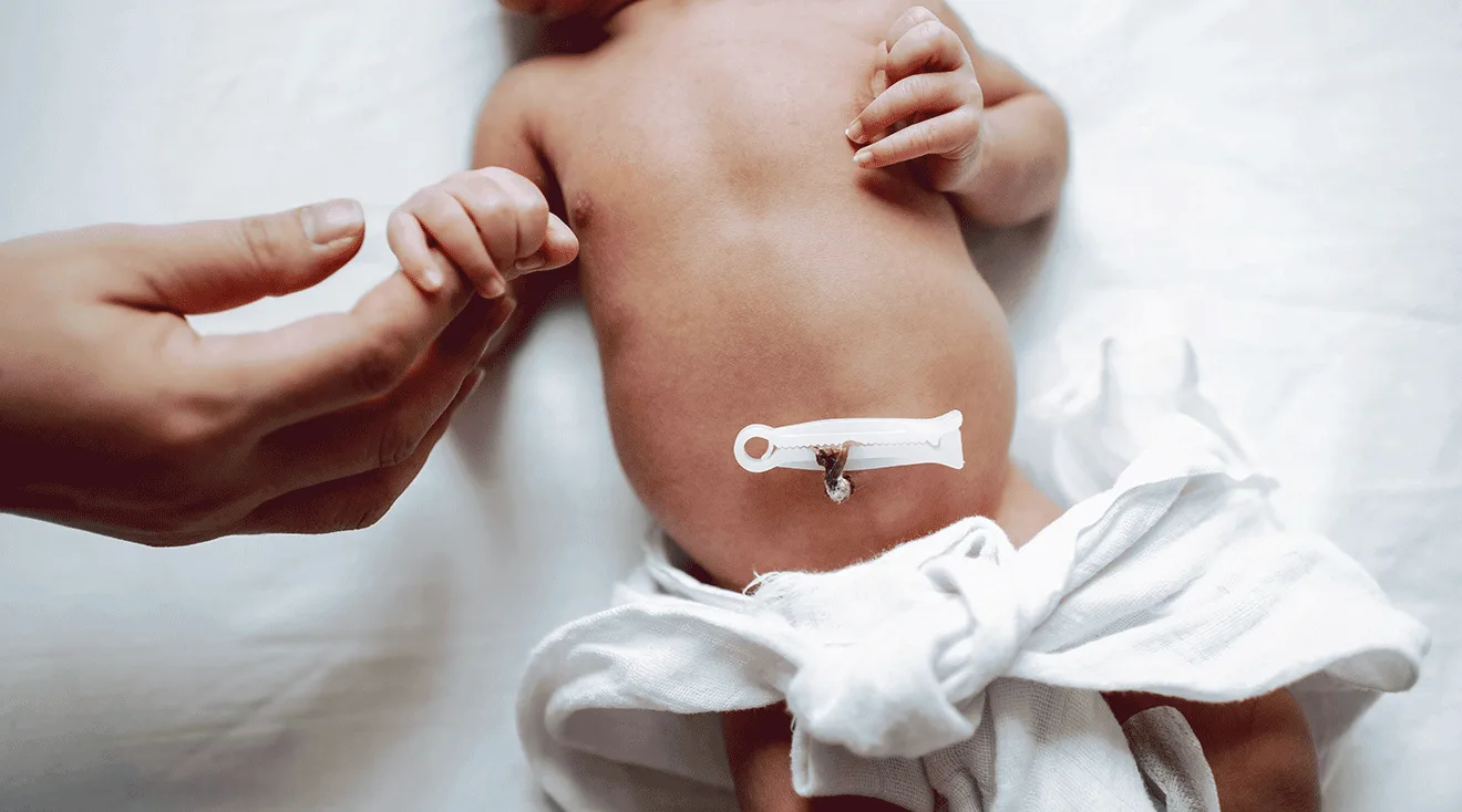 mom holding newborn's hand, close up of newborn belly button