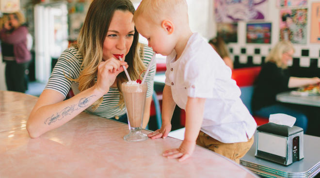mom indulging child with chocolate milkshake demonstrating permissive parenting style