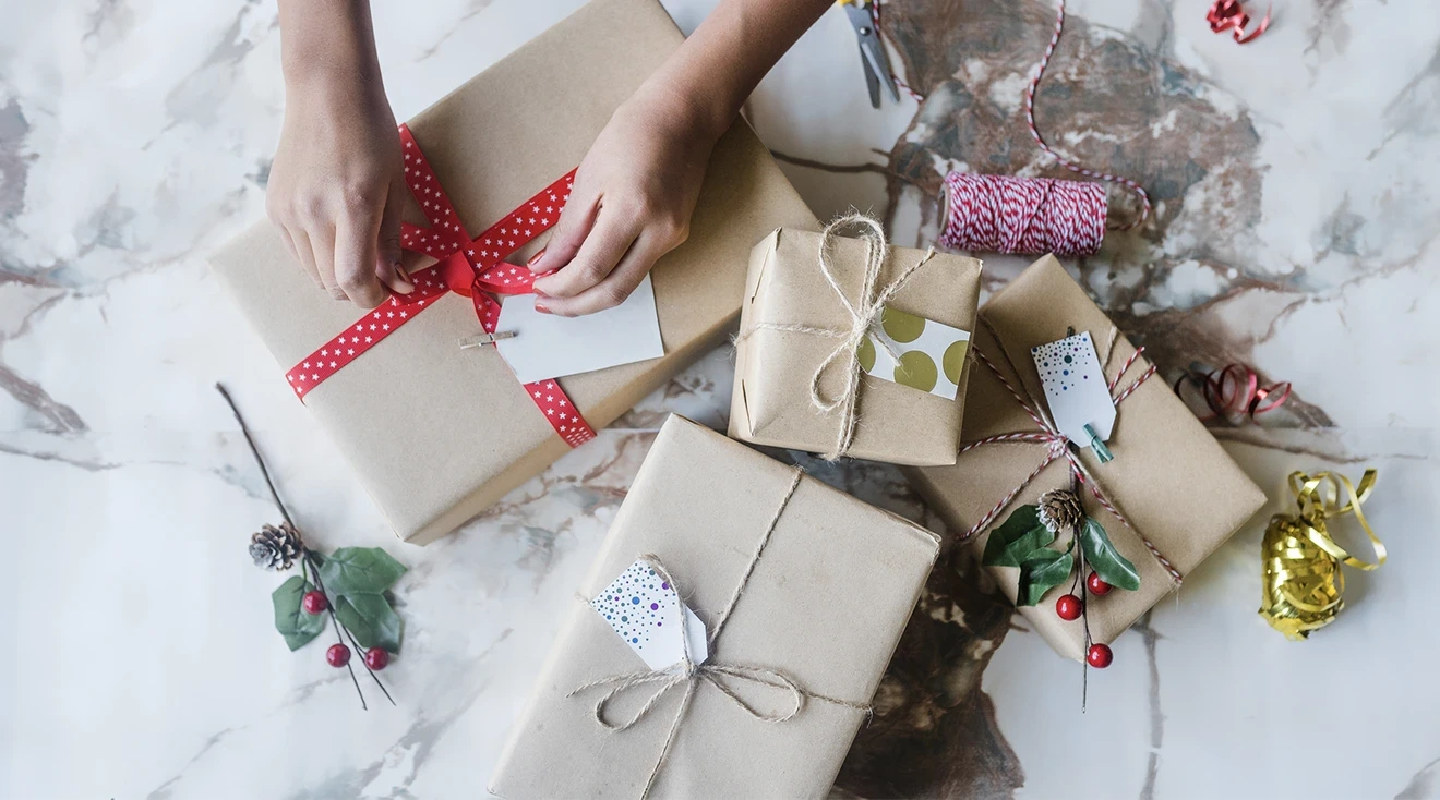 hands wrapping christmas presents