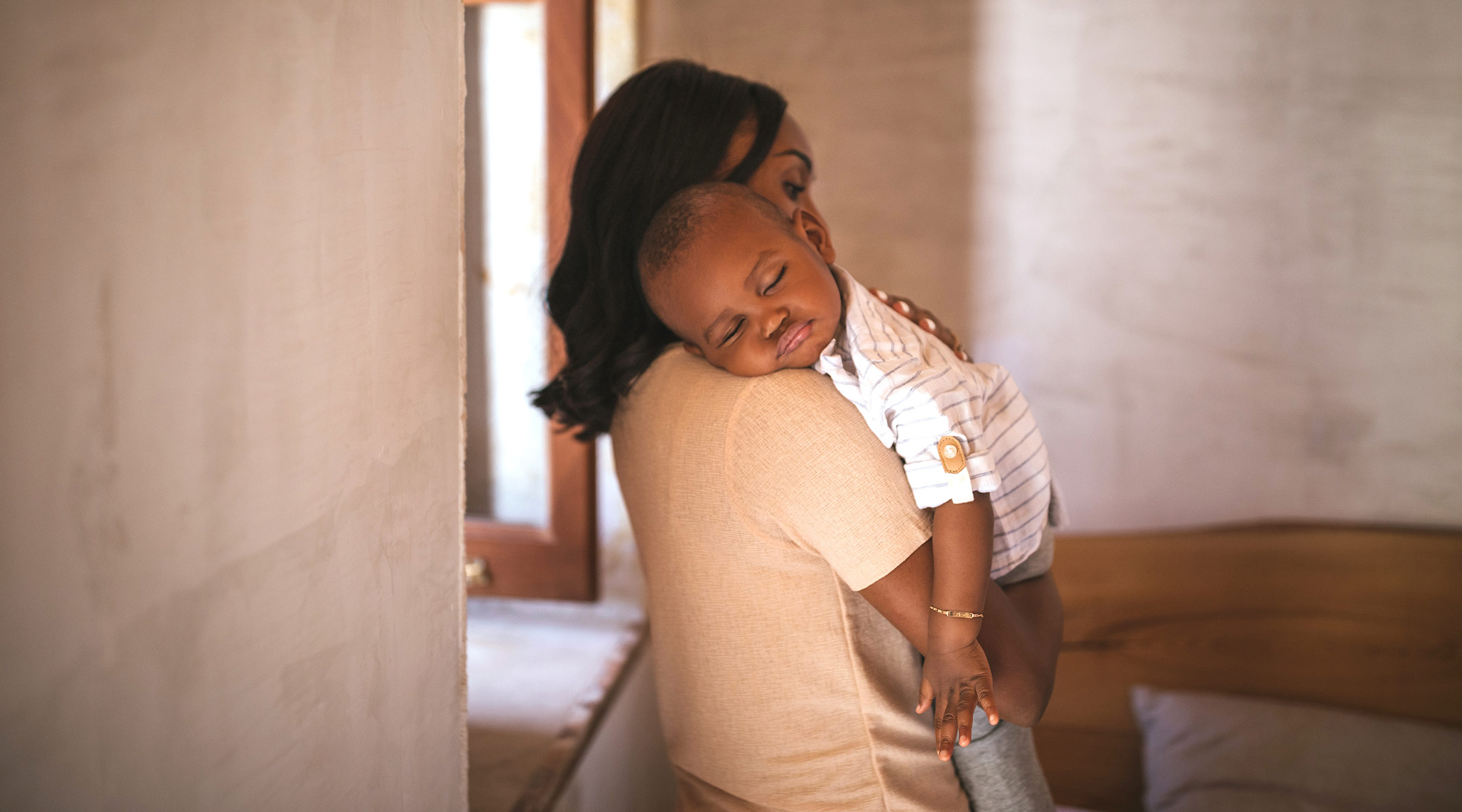 mom holding sleeping child