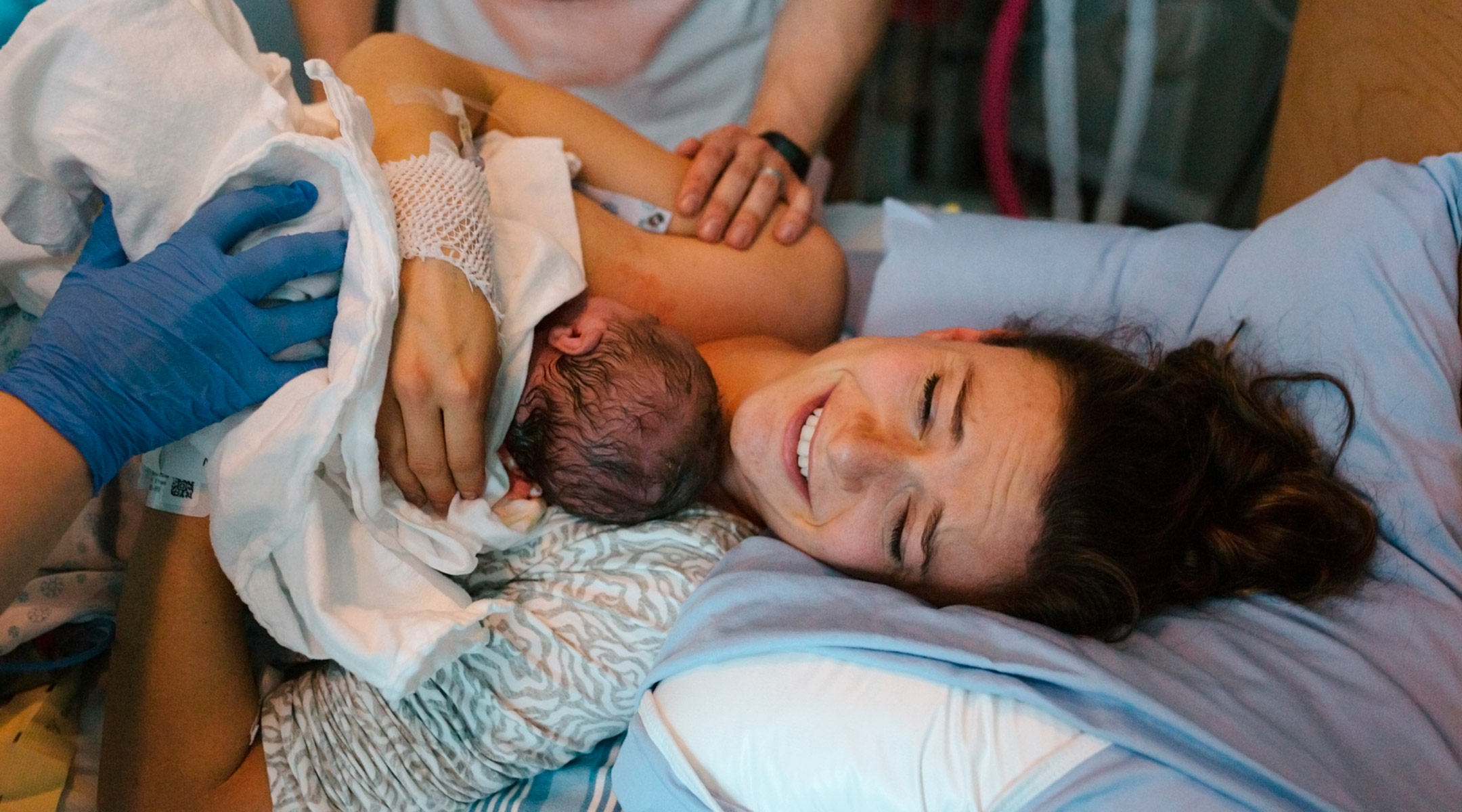 nurse mid-wife assisting in delivery of baby