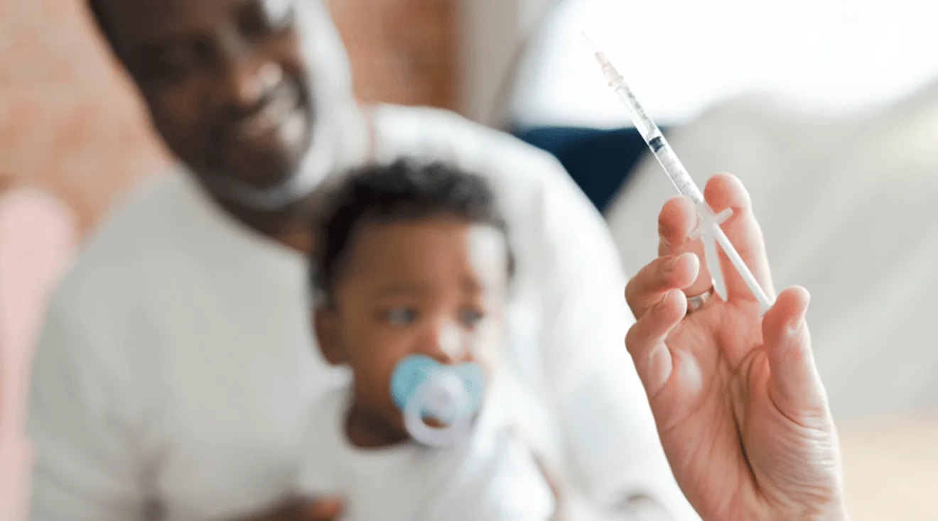 doctor holding vaccination for baby