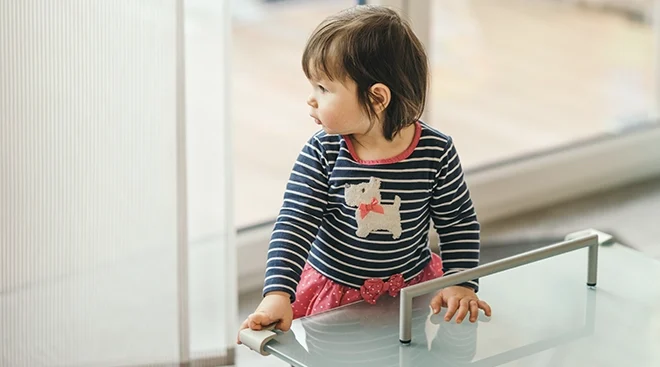toddler standing near coffee table at home