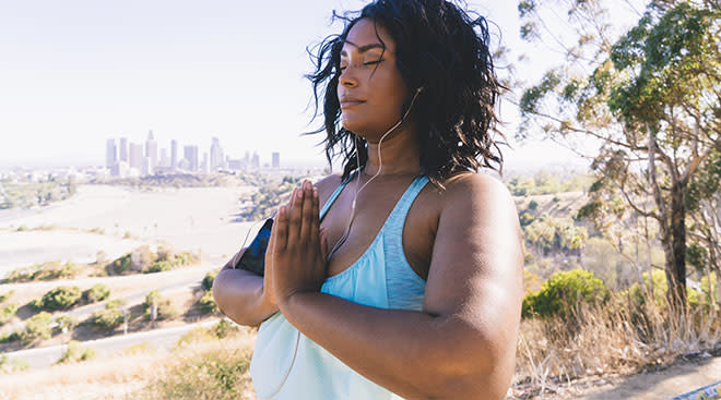 woman listening to her headphones in scenic outdoor setting